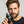 Man holding a black dropper bottle 'Hair Density Serum' with a grey background