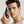 Man holding a bottle of Mr. Jones hair density serum against a neutral background