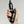 Hand holding two black bottles of Mr. Jones hair density serum and grey defence serum against a grey background