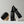 Two black bottles of 'MR. JONES' hair density serum and Grey Defence Serum with a brush on a light grey background