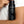 Black shampoo bottle labeled 'MR. JONES Shampoo' held by a hand on a white background