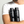 Two bottles of Mr. Jones shampoo and conditioner held by a person wearing a white t-shirt.