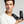 Man holding two bottles of 'MR. JONES Shampoo and Conditioner' hair care products against a grey background