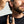 Man applying beard serum from a dropper bottle to his beard.
