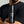 Person holding a black bottle of 'Mr. Jones' beard wash against a neutral background